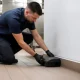 Technician placing a rodent bait station for rodent control in Dubai